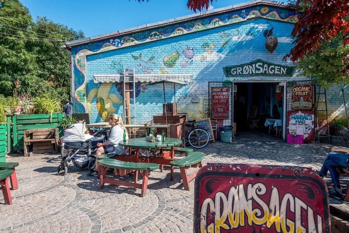 Person sitting outside at a colorful cafe 