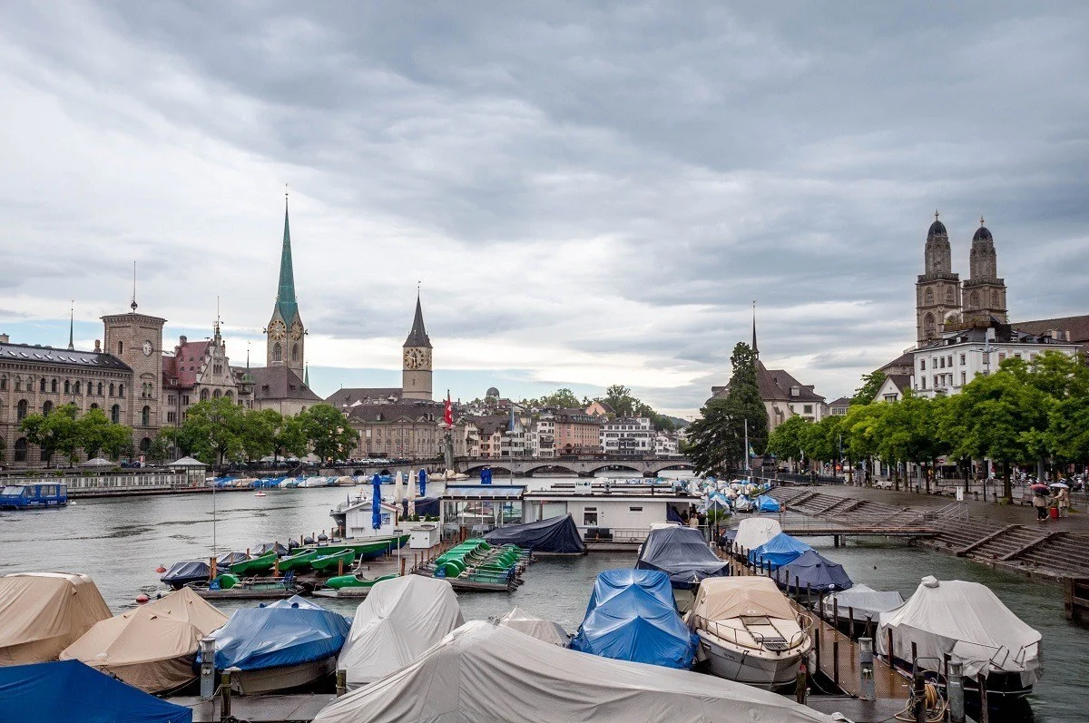 Covered boats with skyline views of the Zurich old town from the Quaibrucke