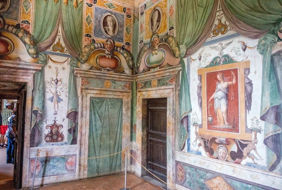 Painted walls showing a woman in a toga and other decorations
