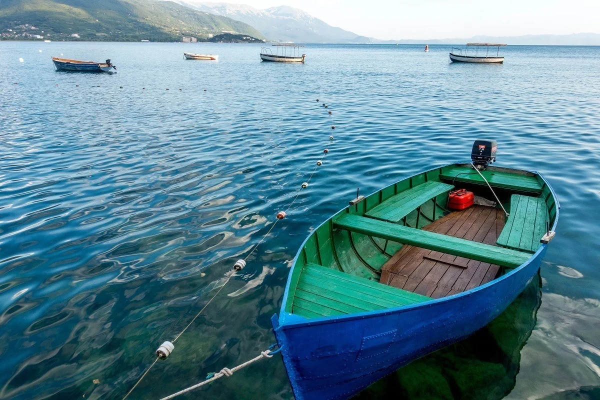A small blue and green boat on the water