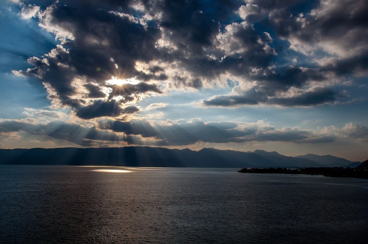 Sun rays peaking through the clouds at Lake Ohrid in North Macedonia