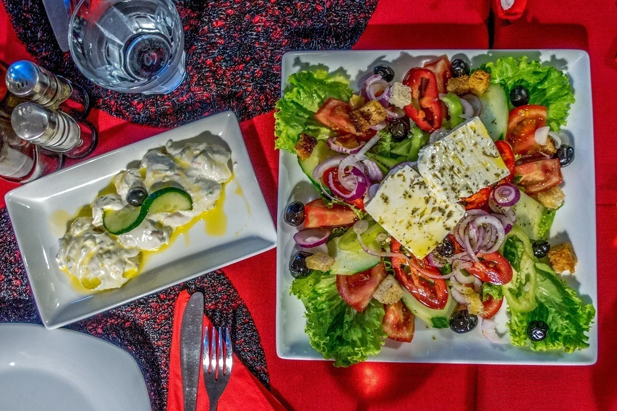 Vegetable salad and garlic yogurt dip called tarator on a table