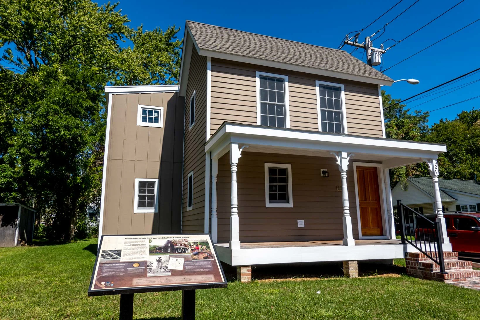 Brown house with information panel in front