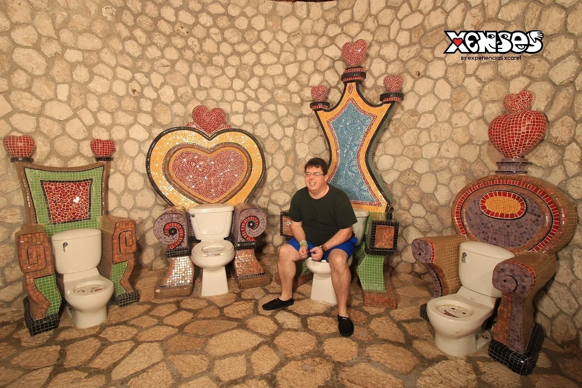 Person sitting on a fake toilet throne at Xenses park in Riviera Maya, Mexico