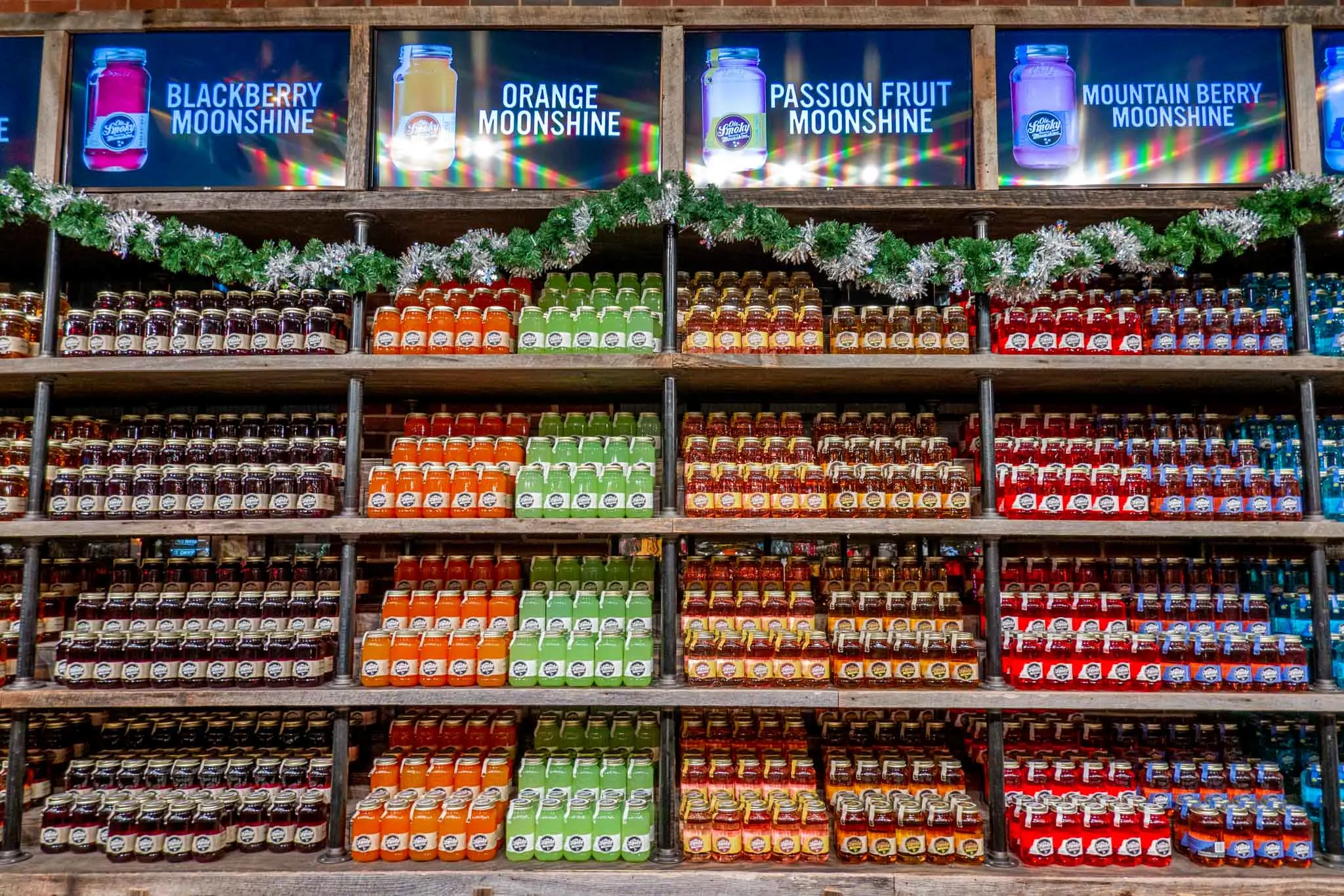 Jars of brightly colored moonshine on shelves at Ole Smoky Distillery in Nashville