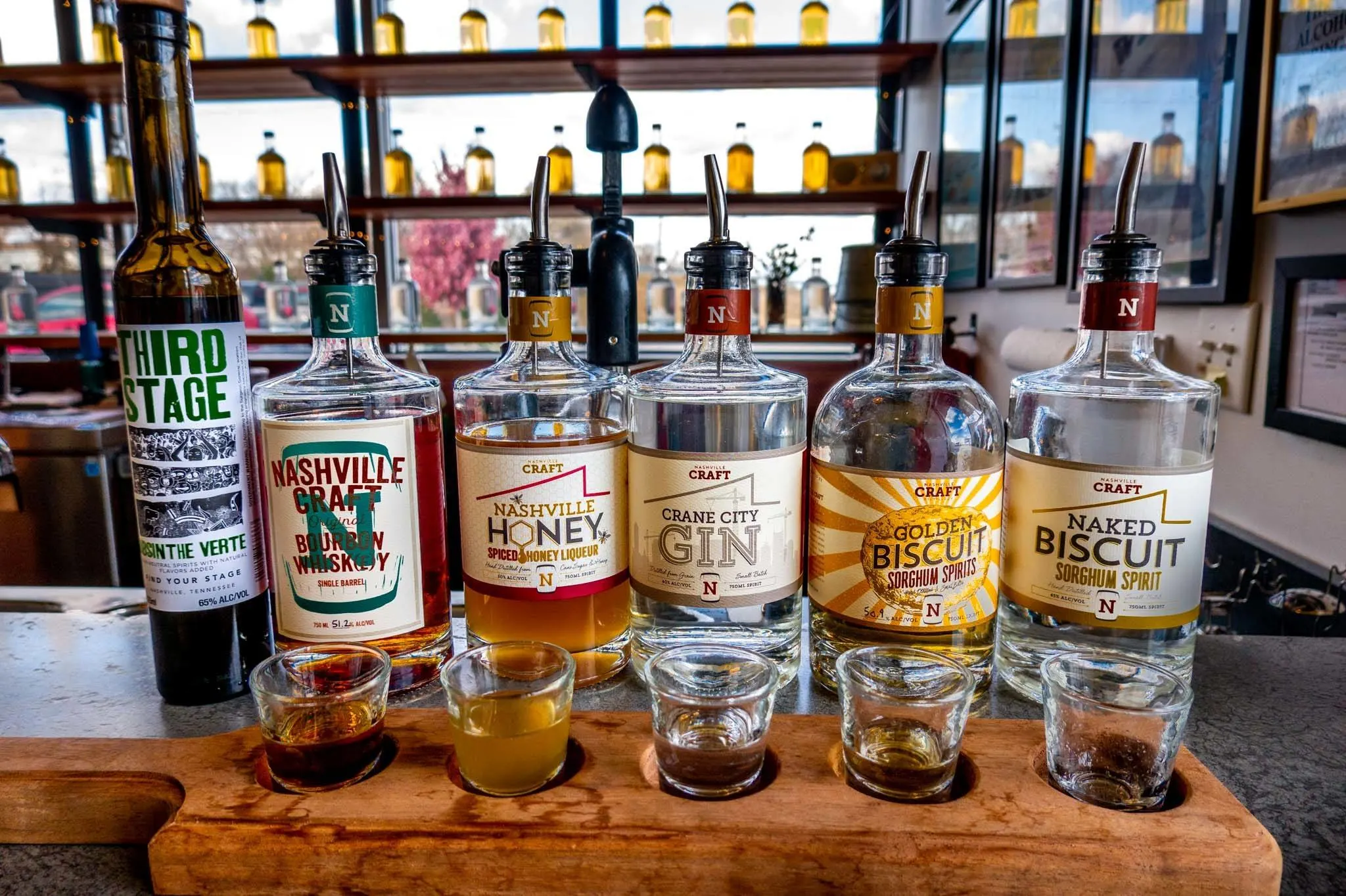 Bottles of spirits and shot glasses on the bar at Nashville Craft Distillery