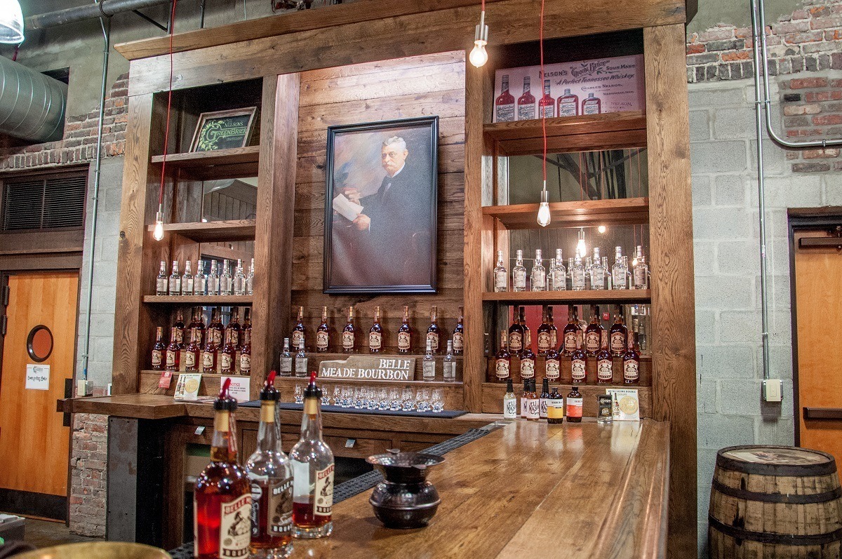 Tasting room bar at Nelson's Green Brier Distillery along with a portrait of Charles Nelson