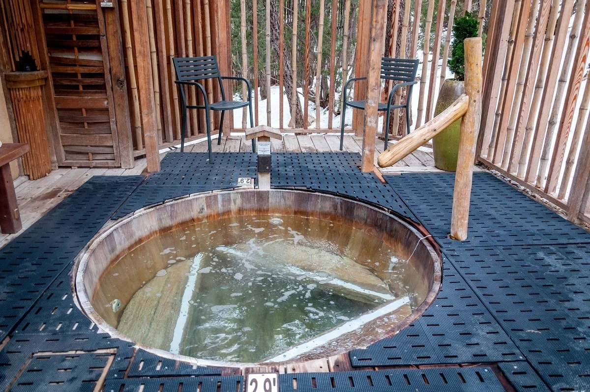 Wooden hot tub surrounded by a black non-slip mat