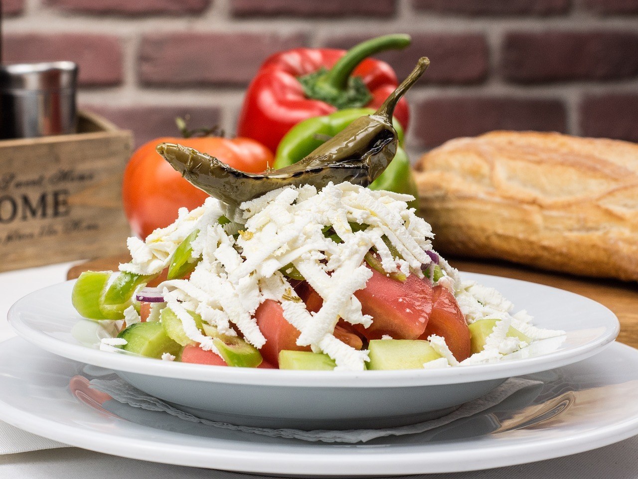 Salad of tomato, cucumber, and shredded cheese