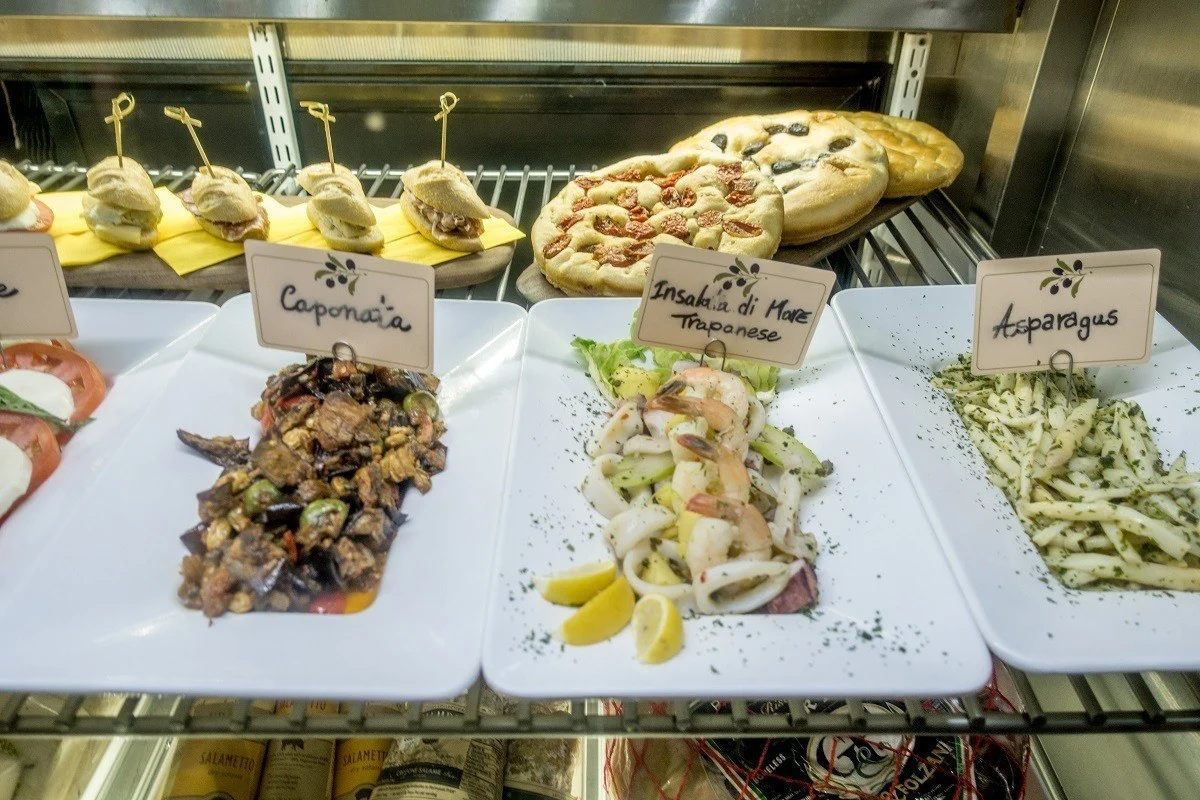 Italian salads and breads in display case