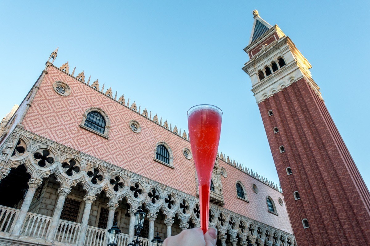 Cocktail in front of a replica Italian tower and building