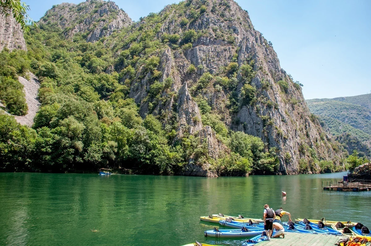 Kayaks in the water surrounded by mountains