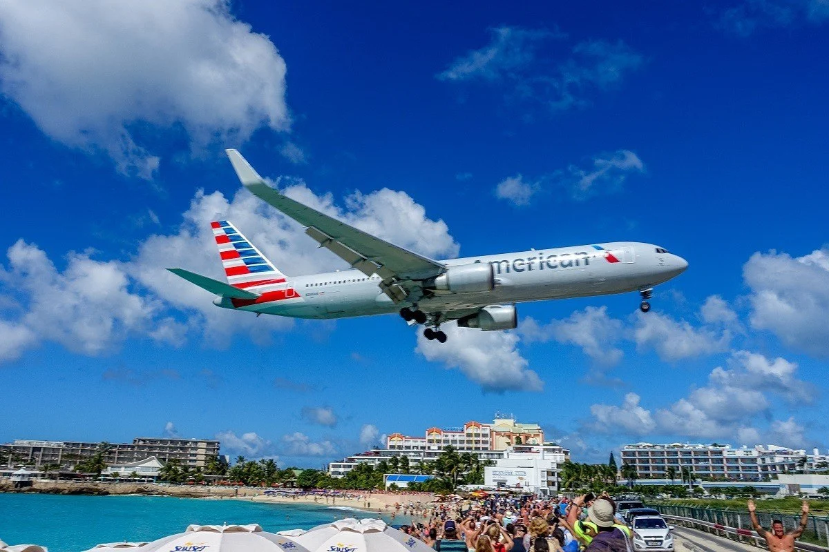 Jet landing over people on a beach