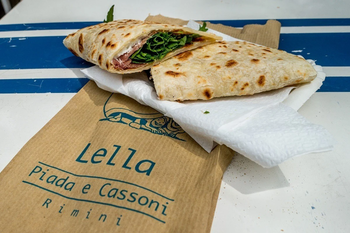 A piadina stuffed with cheese, meat, and vegetables