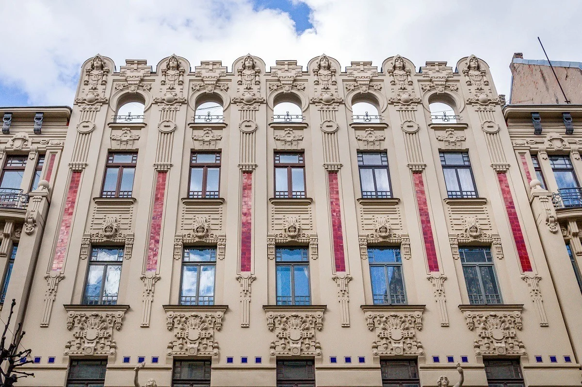 Art Nouveau building with carved heads and decorations.