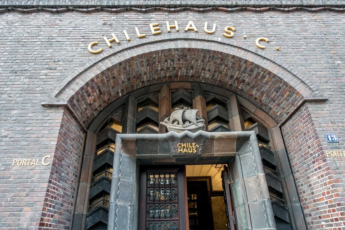 Exterior of brick building with a boat over the door, The Chilehaus