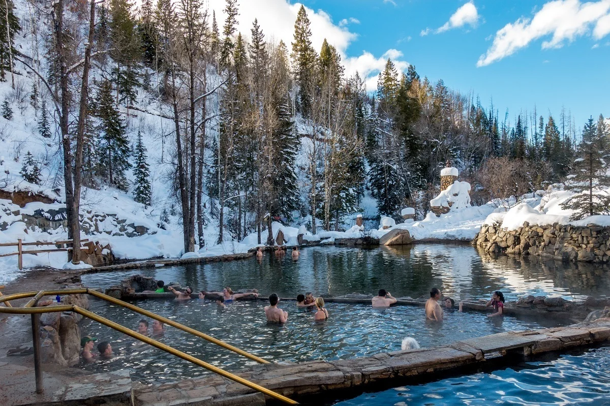 People in the Strawberry Park Hot Springs, the best natural hot springs in Colorado