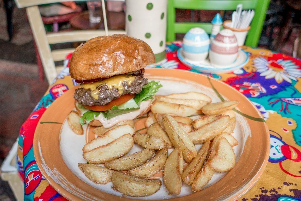 Hamburger and French fries on a table.