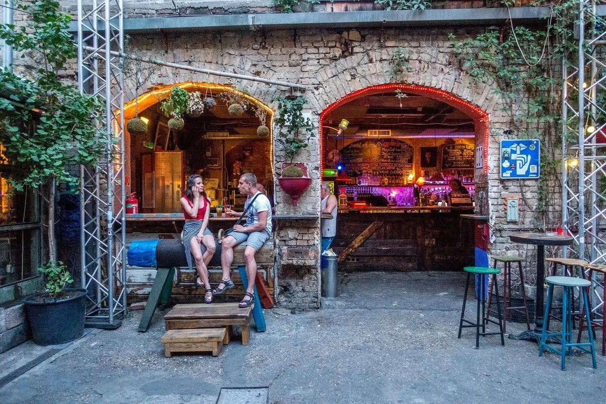 People sitting on pommel horse in a courtyard