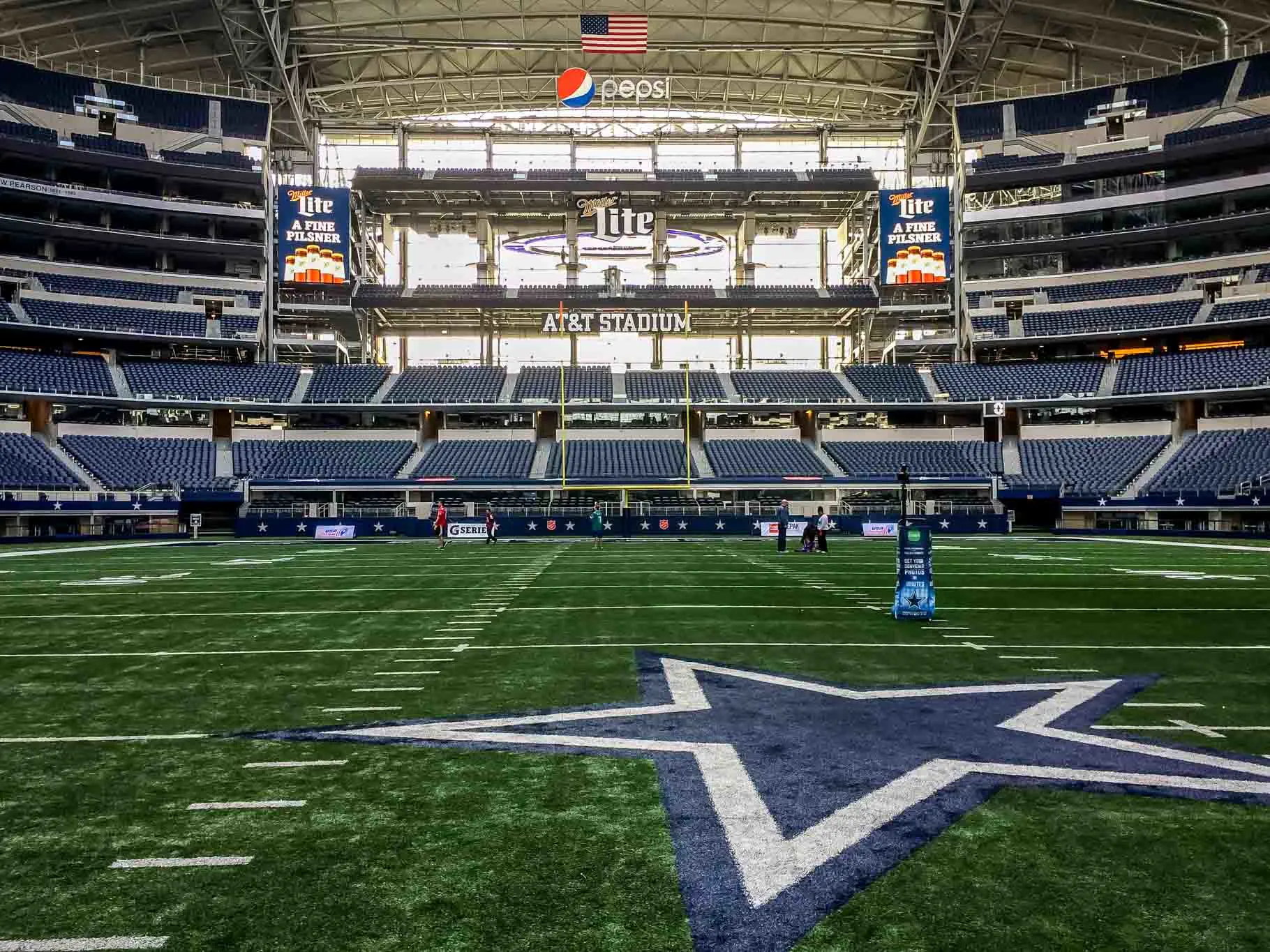 View from the field of a large football stadium with a blue and silver star.