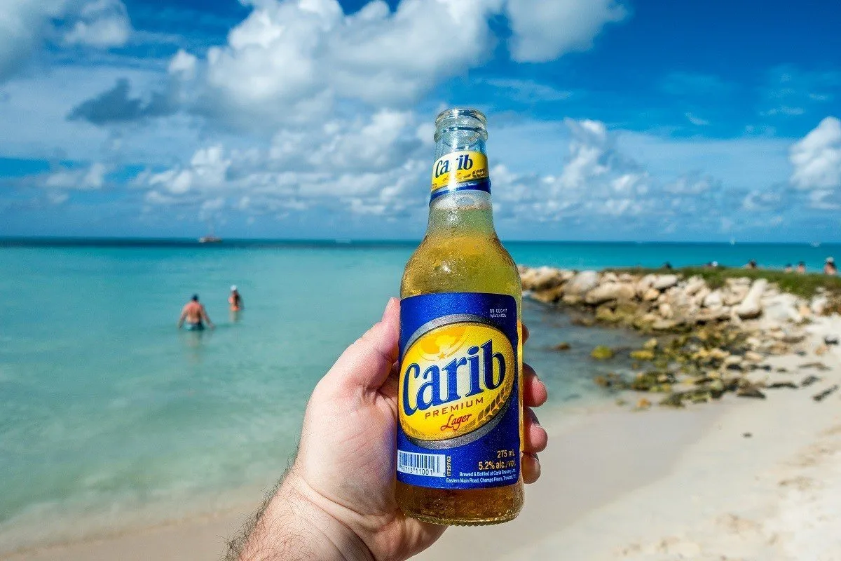 Bottle of Carib on the beach