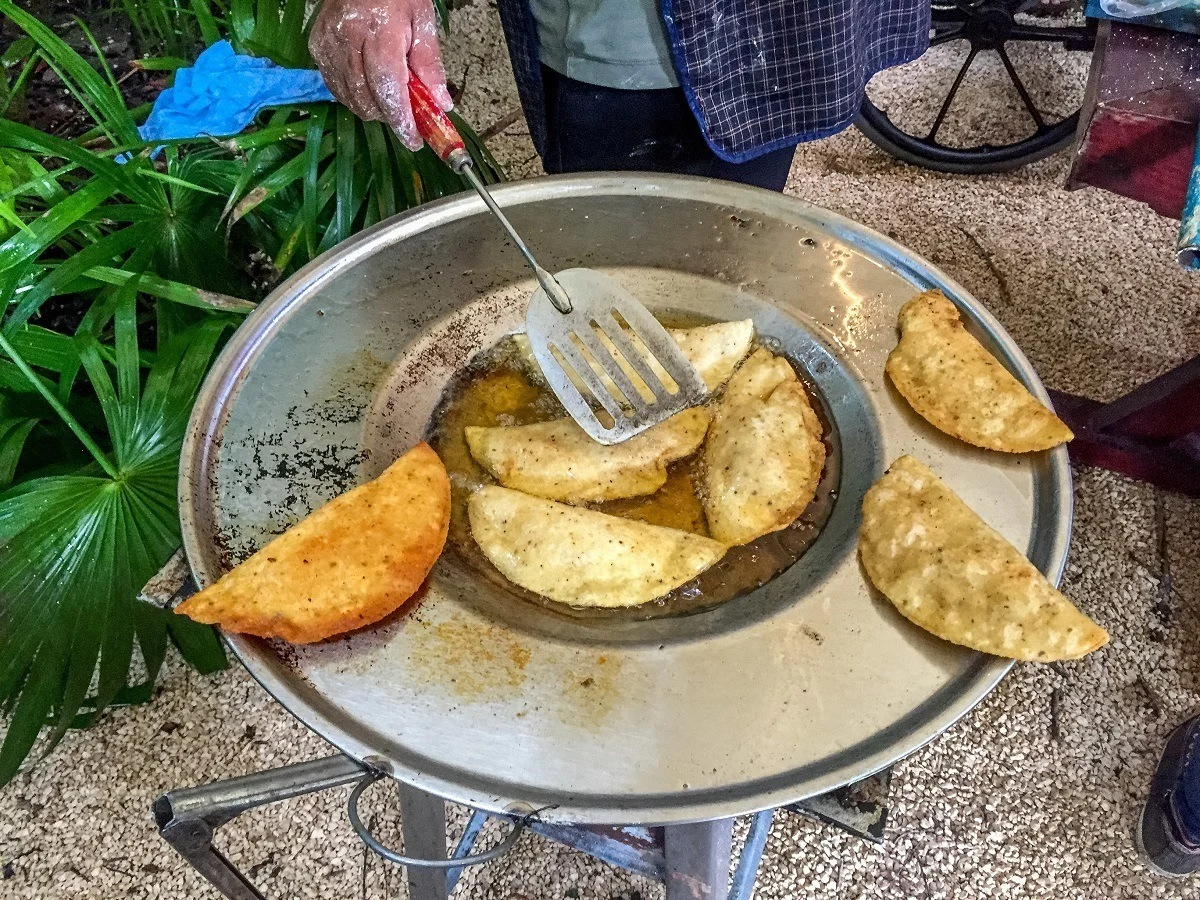 Molotes frying in pan