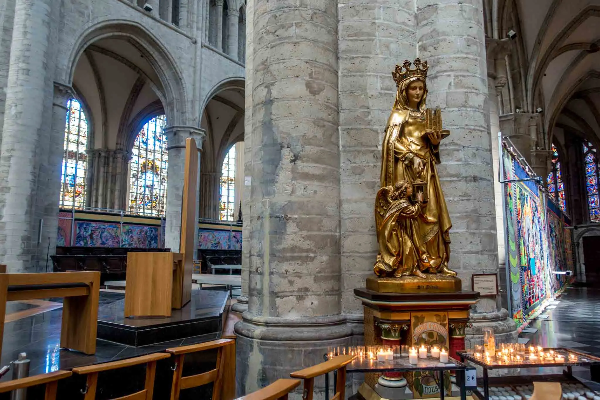 Statue of a woman holding a miniature building.