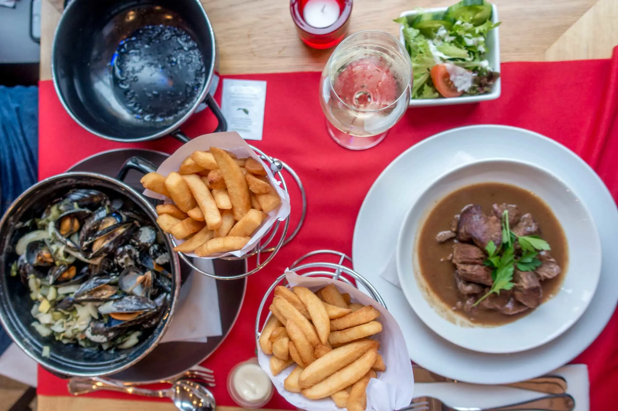 Frites, mussels, and other Belgian food on table