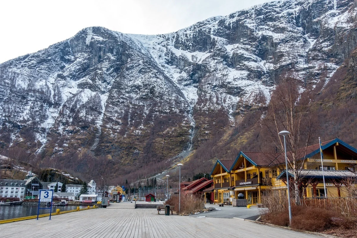 Buildings and harbor flanked by a snow-covered mountain.