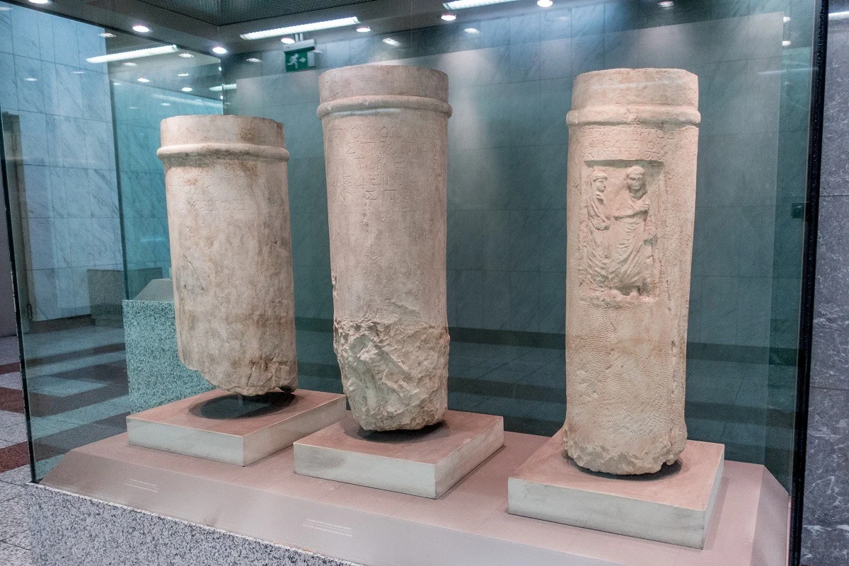 Ancient pillars displayed behind glass in the metro