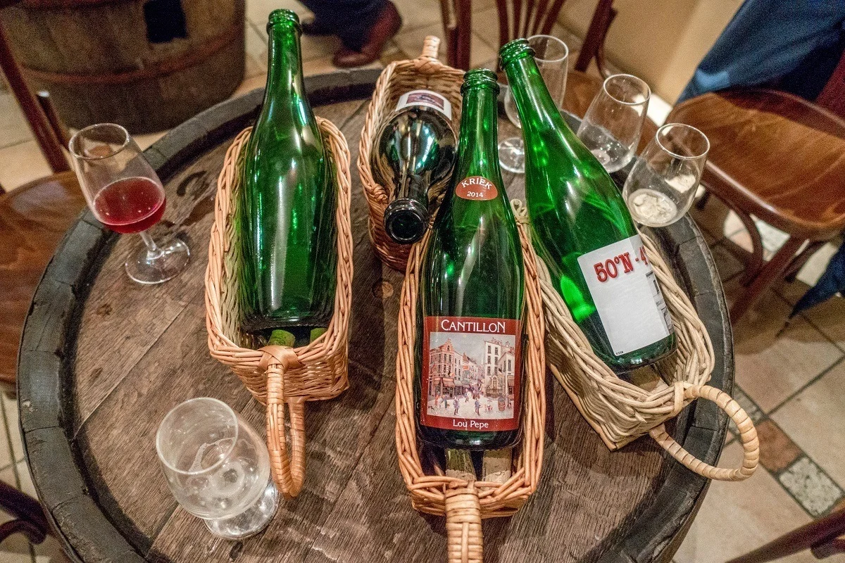 Bottles of beer and glasses at Brasserie Cantillon in Brussels, Belgium