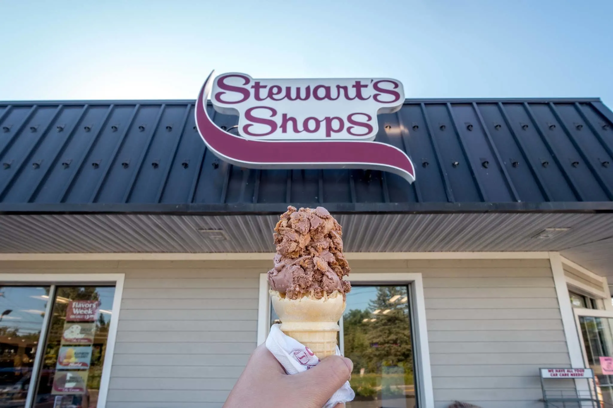 Ice cream cone in front of "Stewart's Shops" sign.