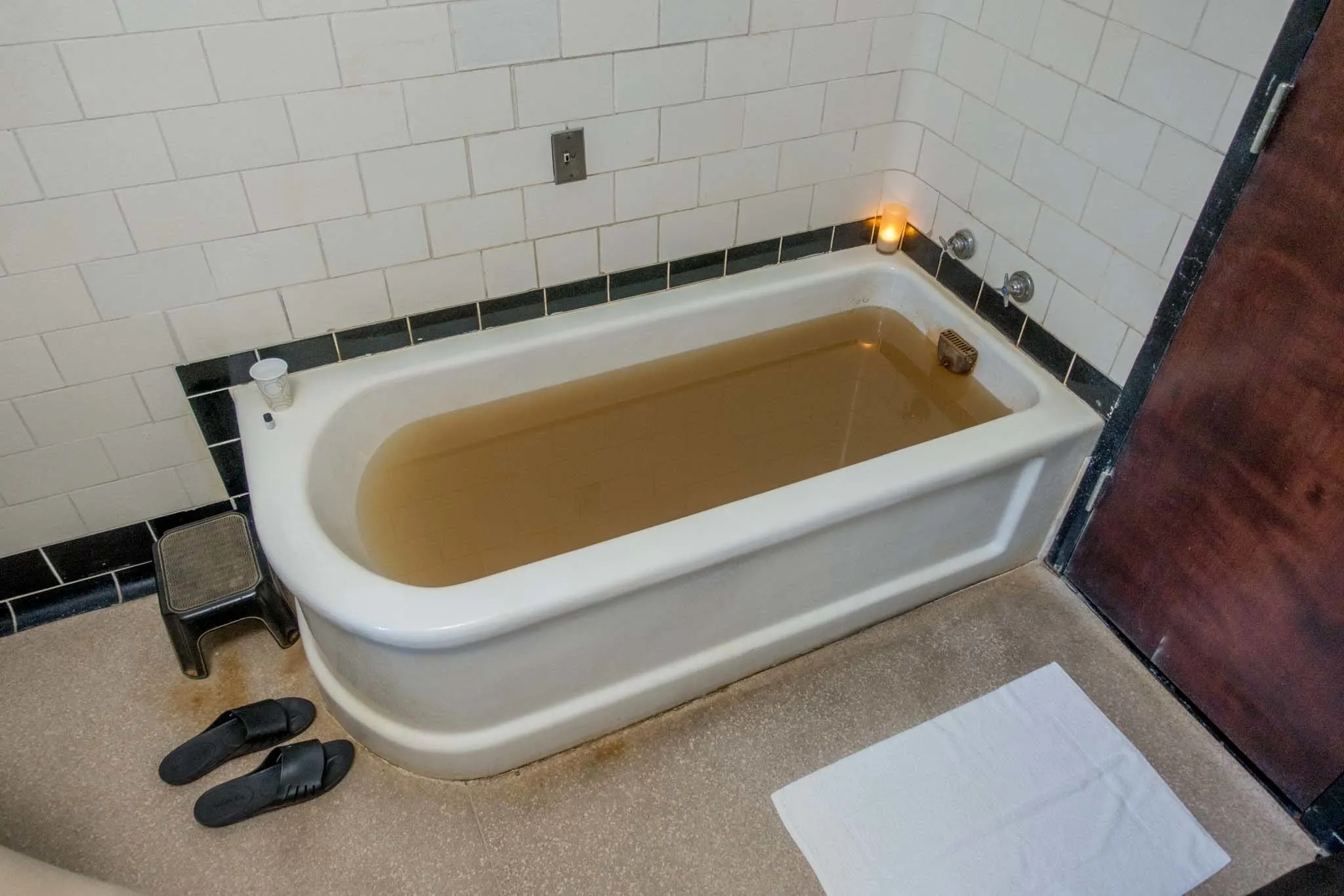 Bathtub with yellow water.