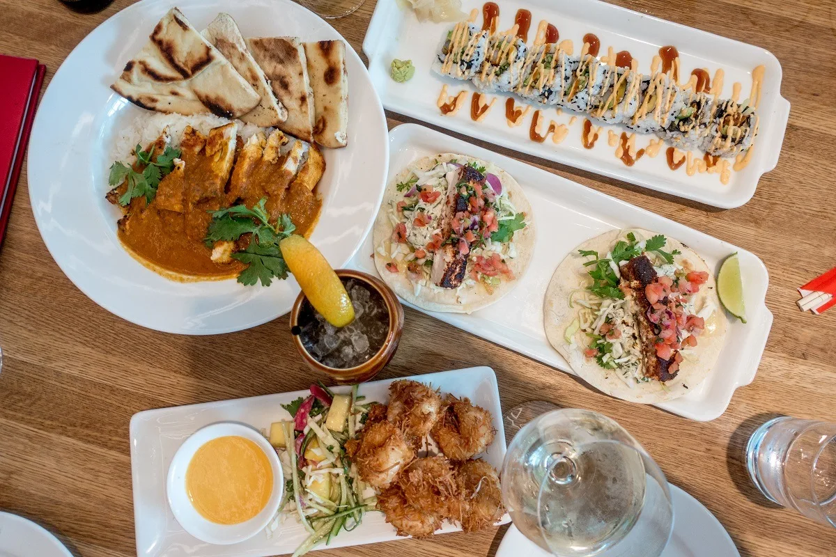 Sushi, tacos, and other food on table