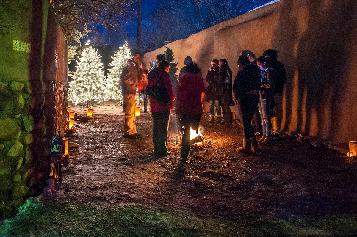 Carolers around the luminaries on Canyon Road