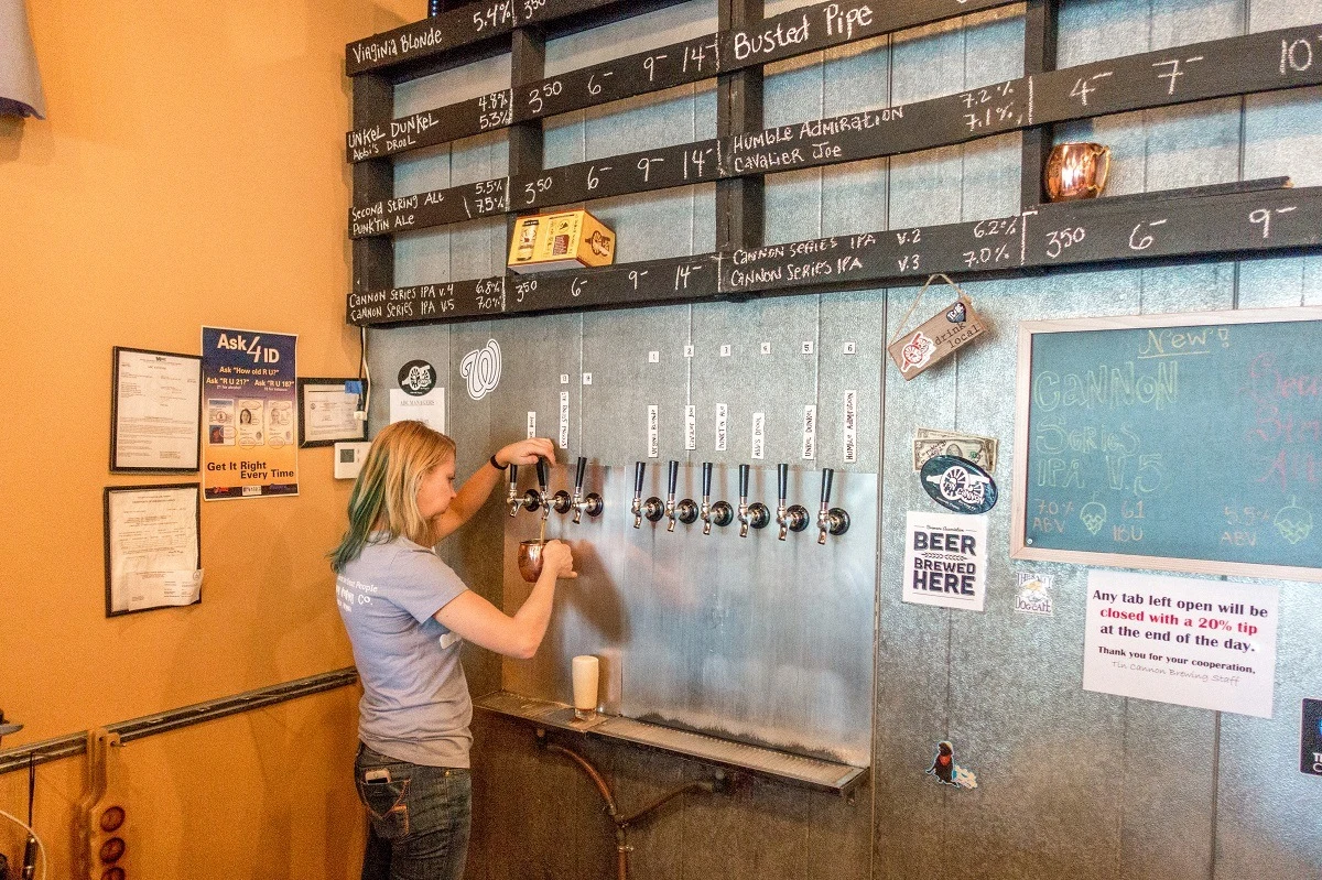 Woman pouring beer at Tin Cannon Brewery
