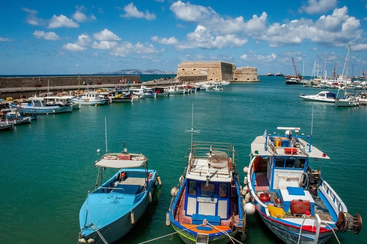 Boats and stone fort in the Port of Heraklion in Crete, Greece