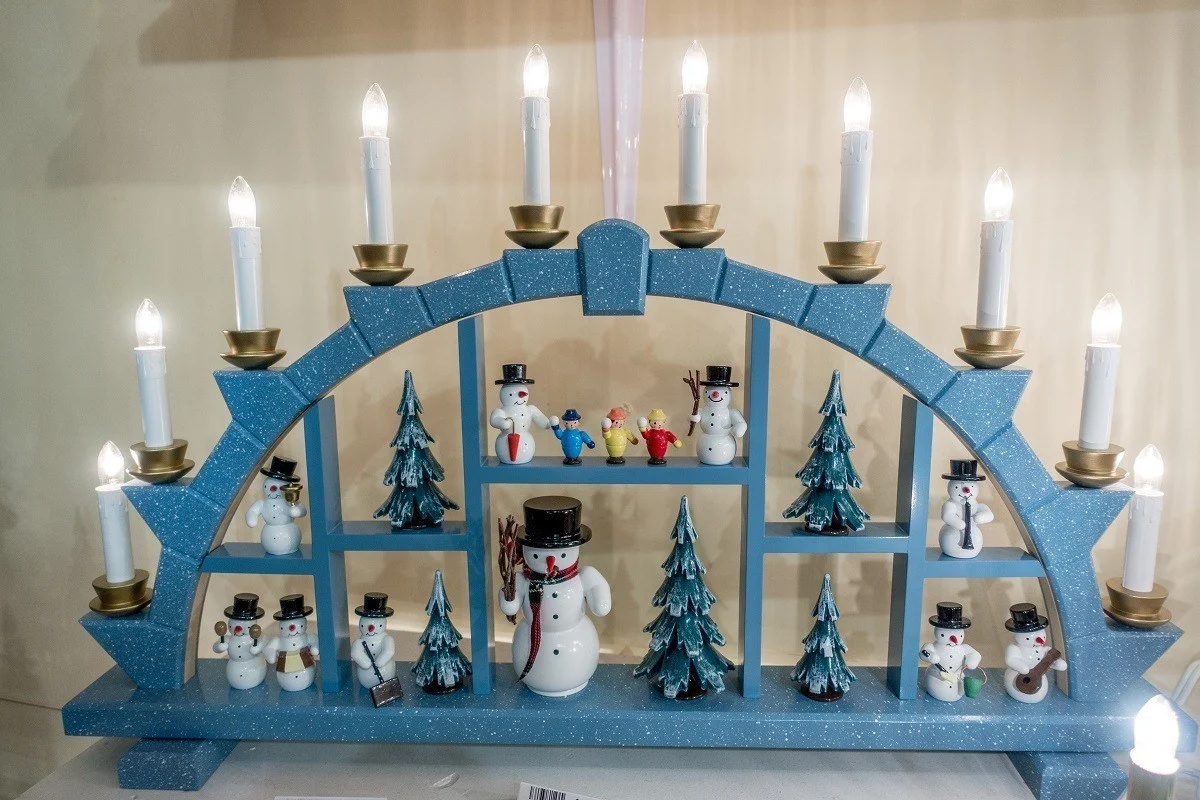 German schwibbogen decoration with toy snowmen and electric candles