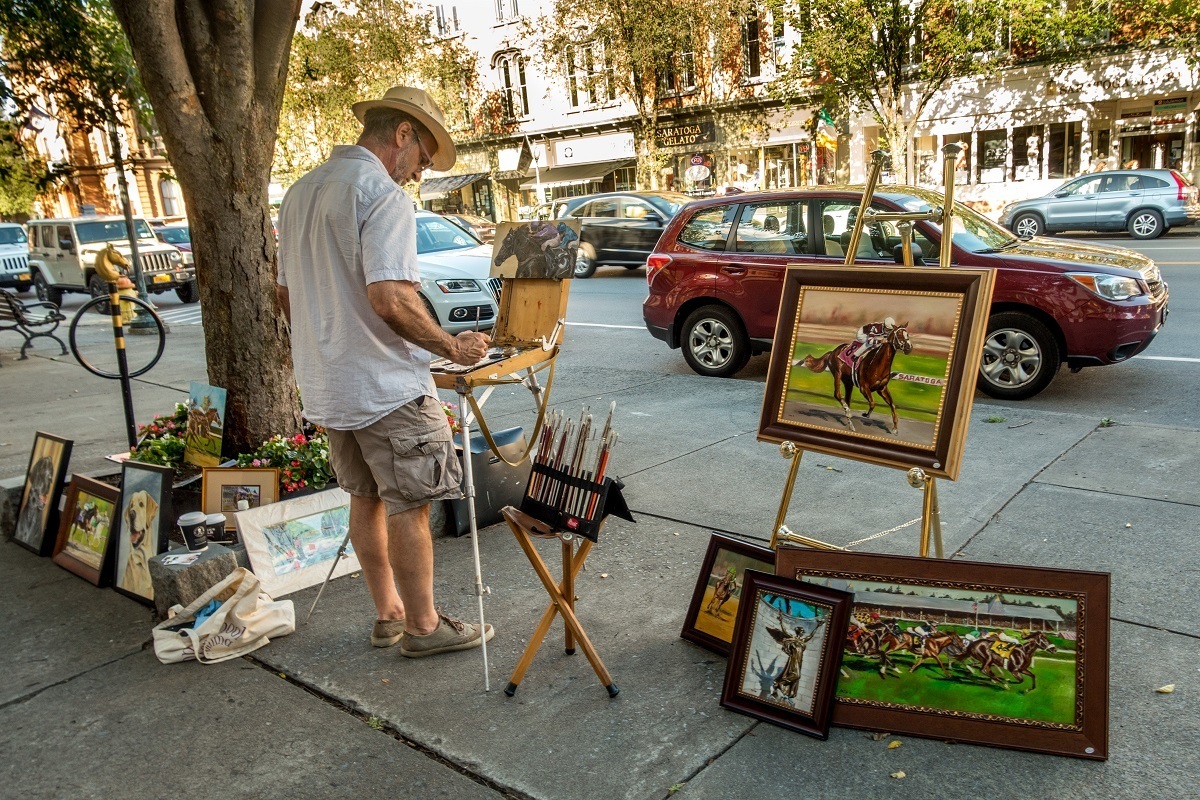 Man painting on street in Saratoga Springs, New York