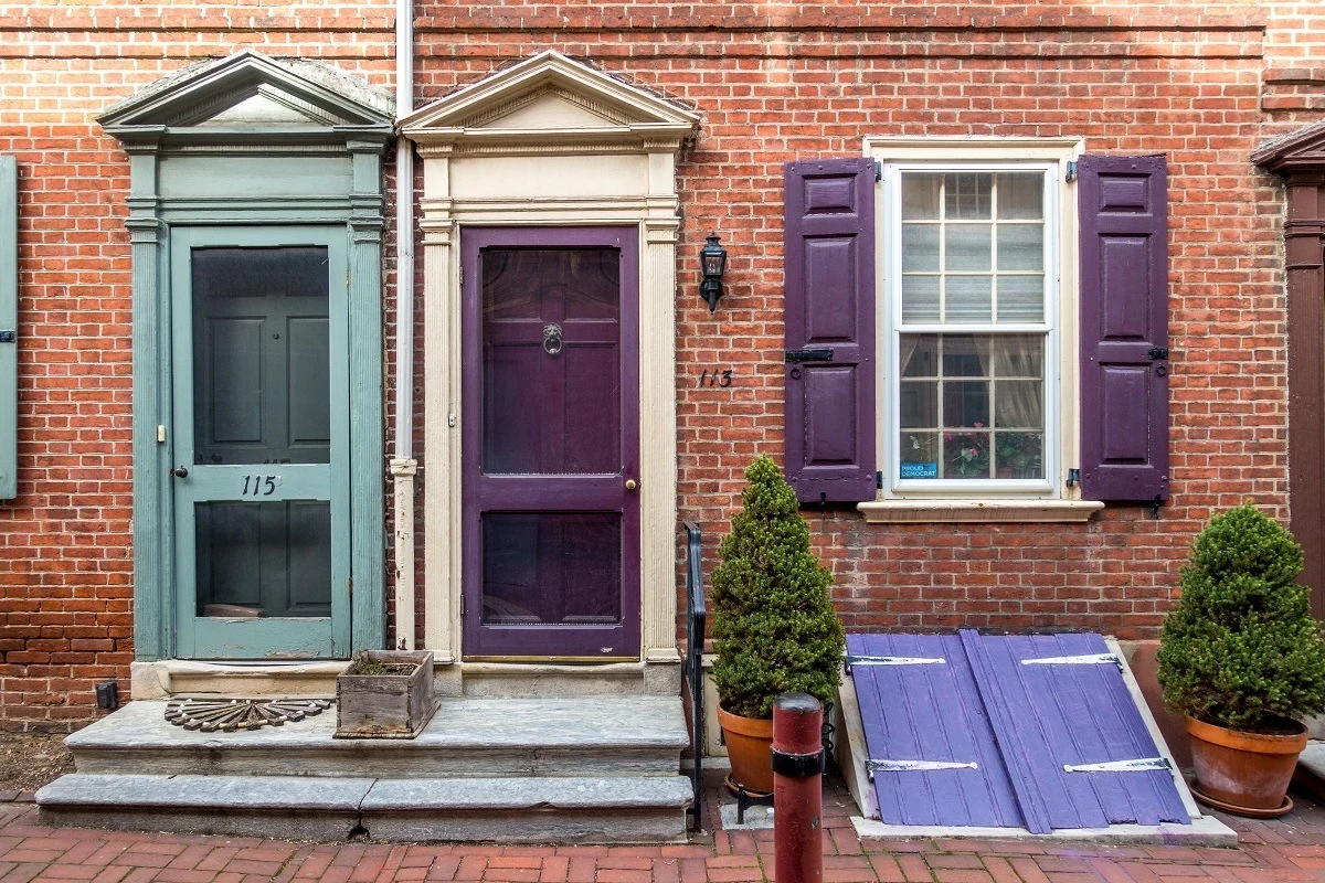 Brick row homes with brightly painted doors 