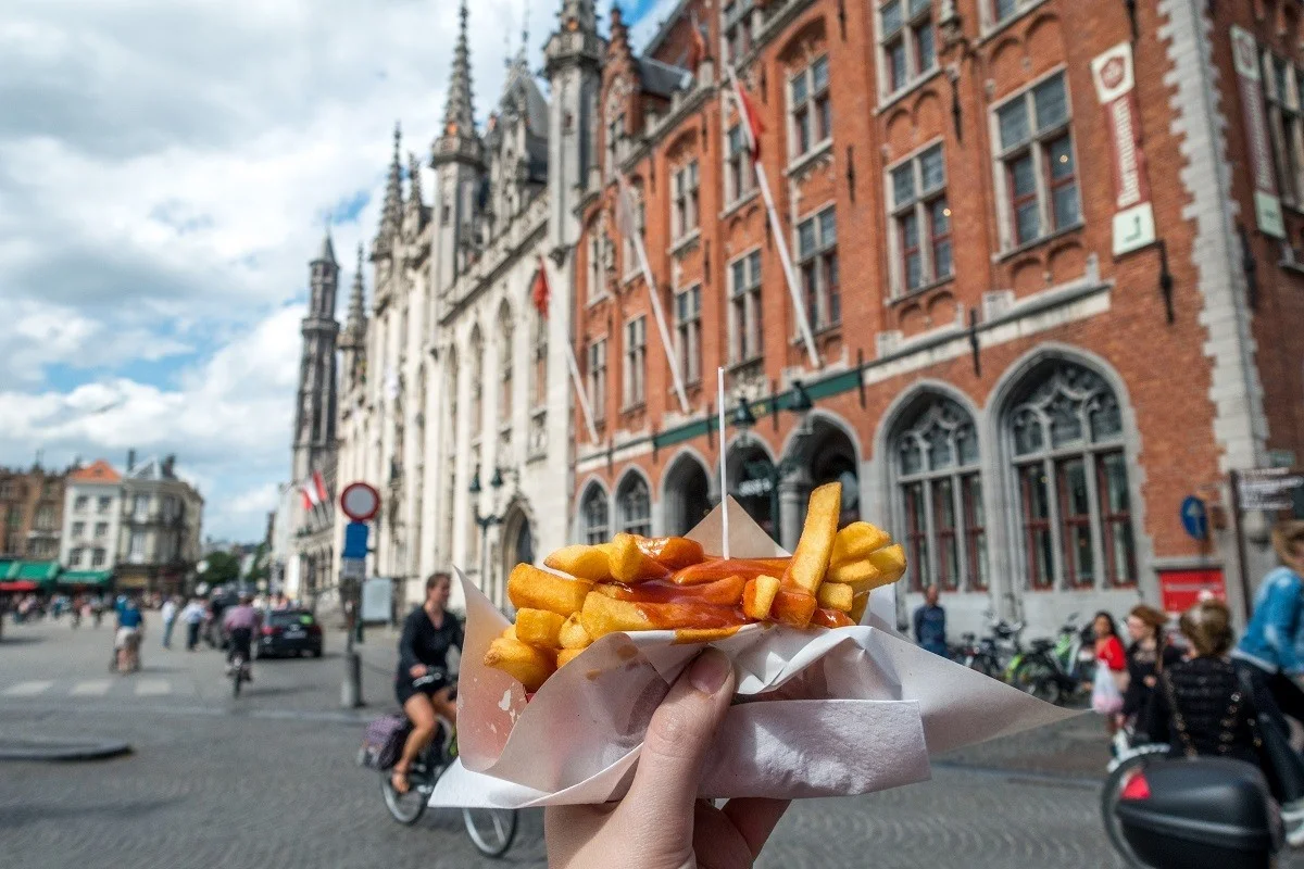 French fries in front of a building in Bruges market square