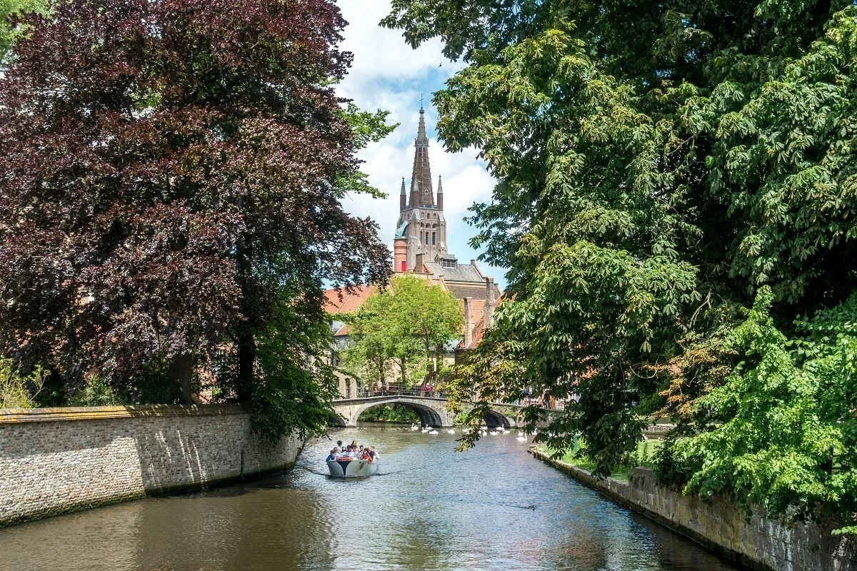 Boat in a canal with a church in the distance