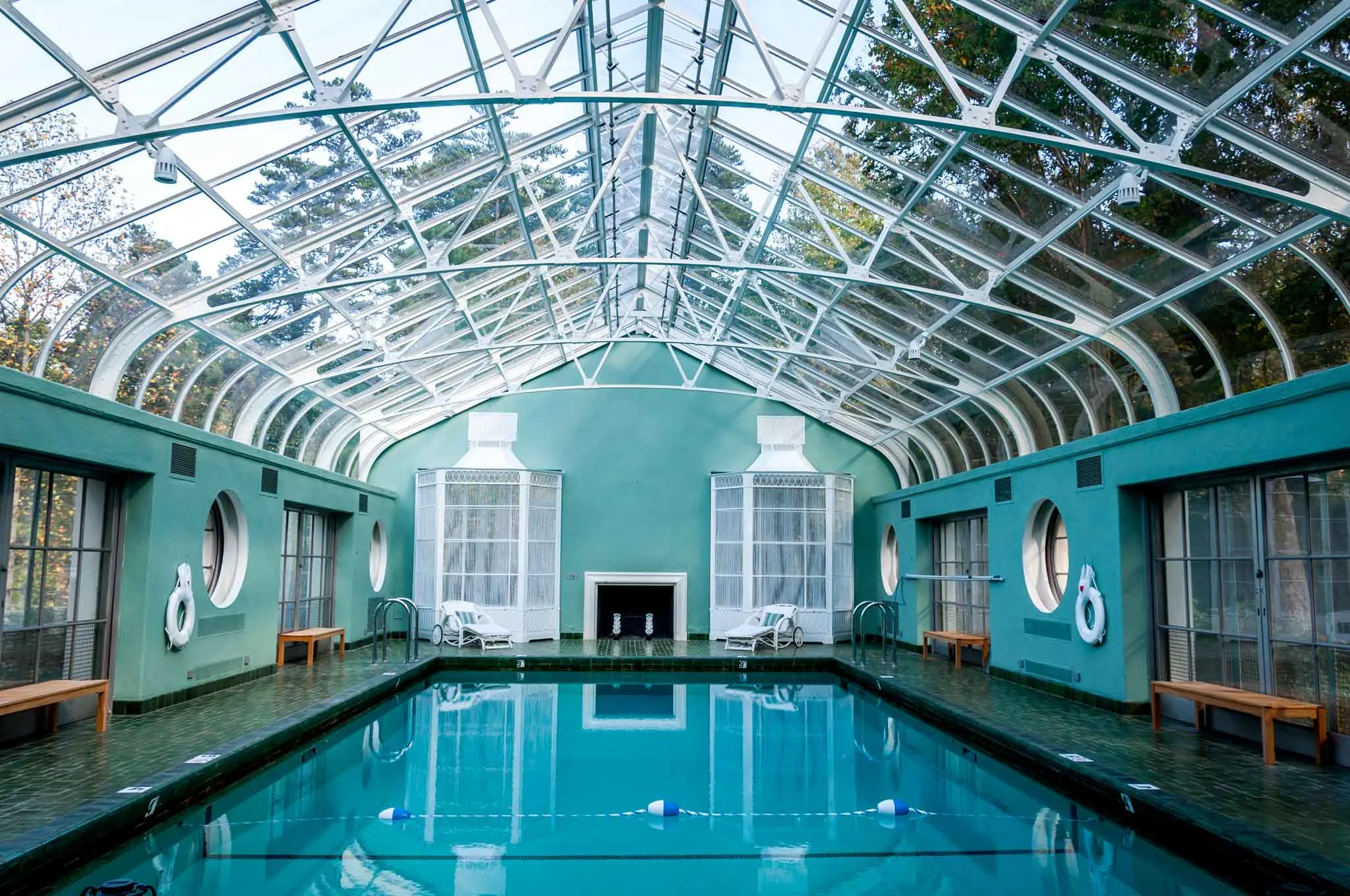 Indoor pool in room with a glass ceiling. 