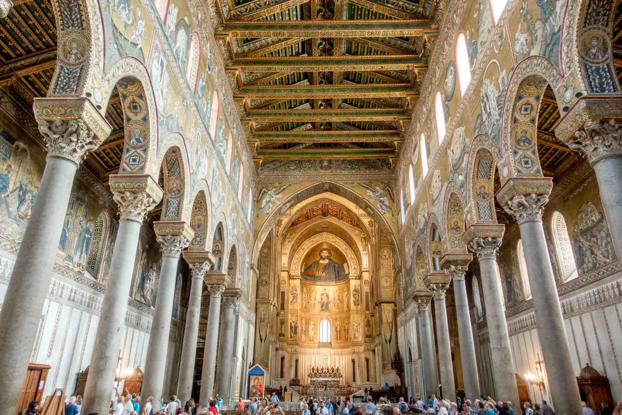 Interior of a cathedral decorated with gold mosaics.
