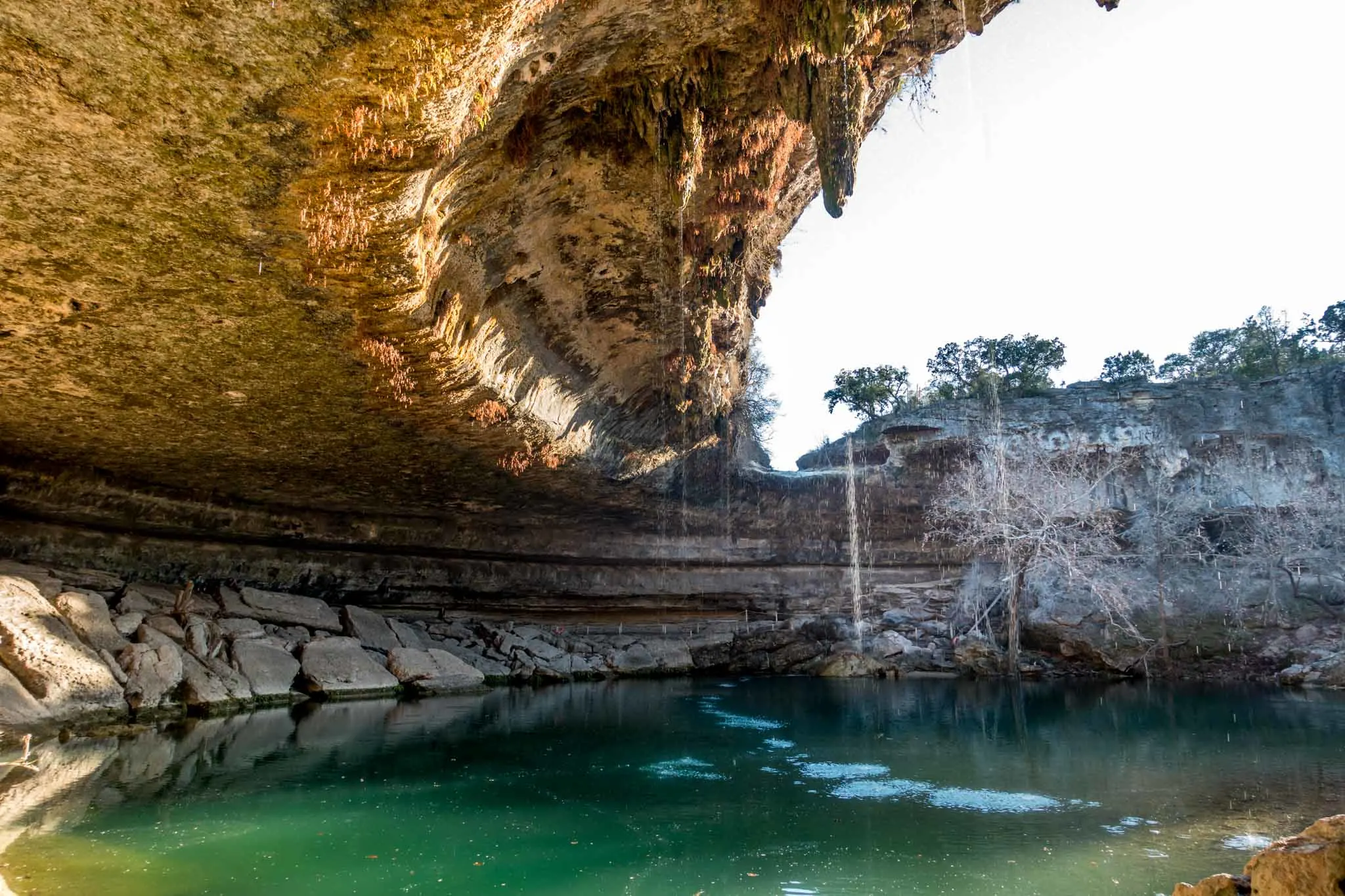 Water dripping into a large natural pool.