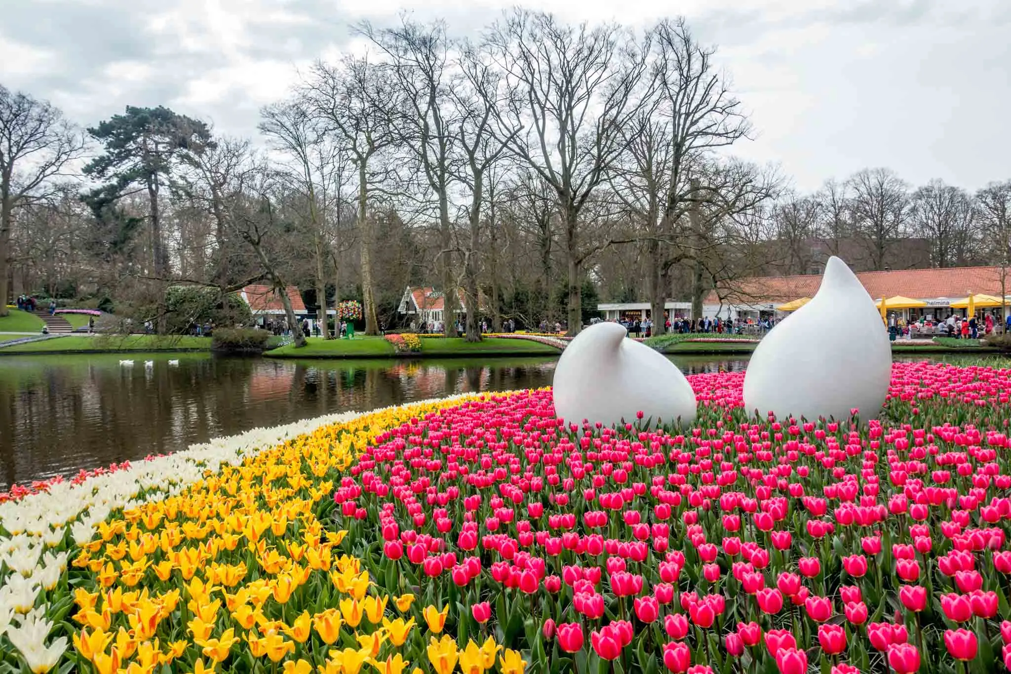 Tulips and sculptures in a pond.
