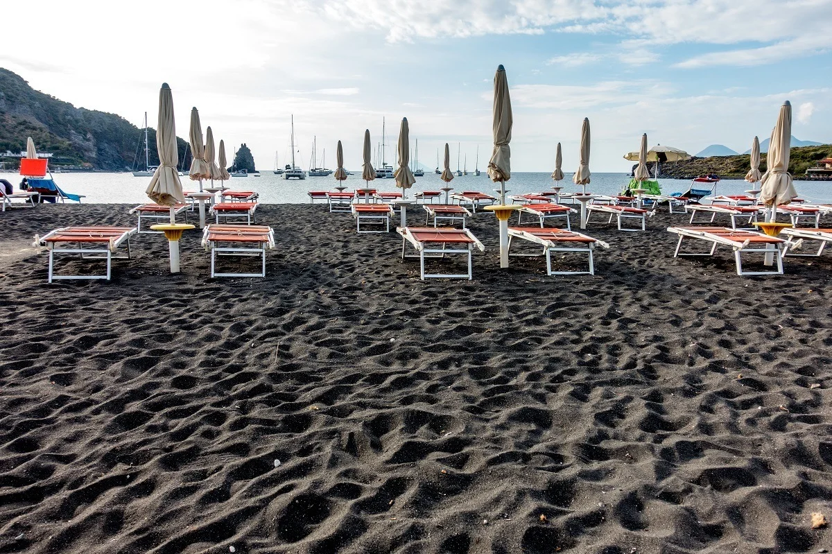 Lounge chairs for relaxing on the black sand beach on Vulcano