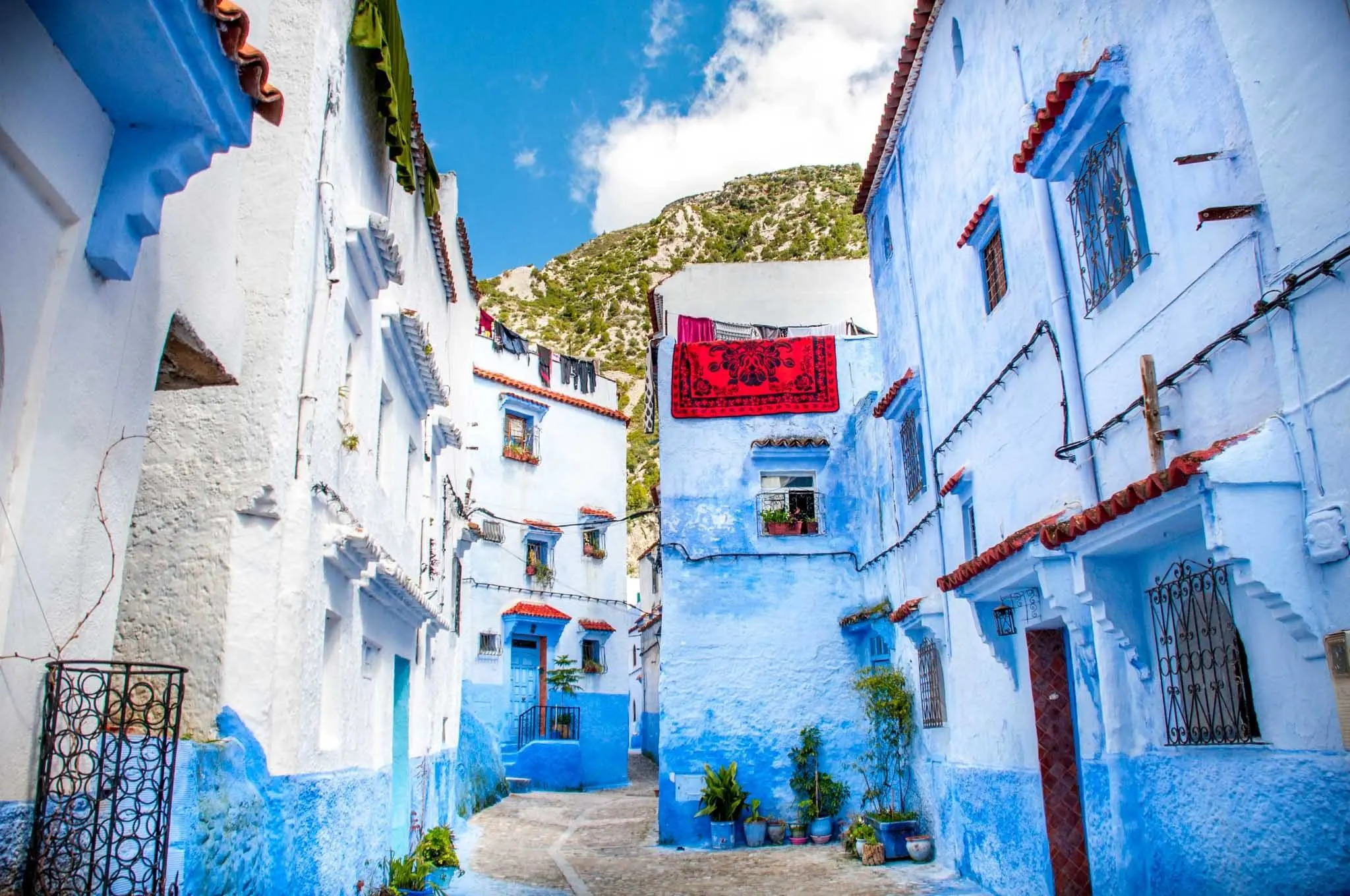 Blue walls on both sides of a pedestrian street in Chefchaouen
