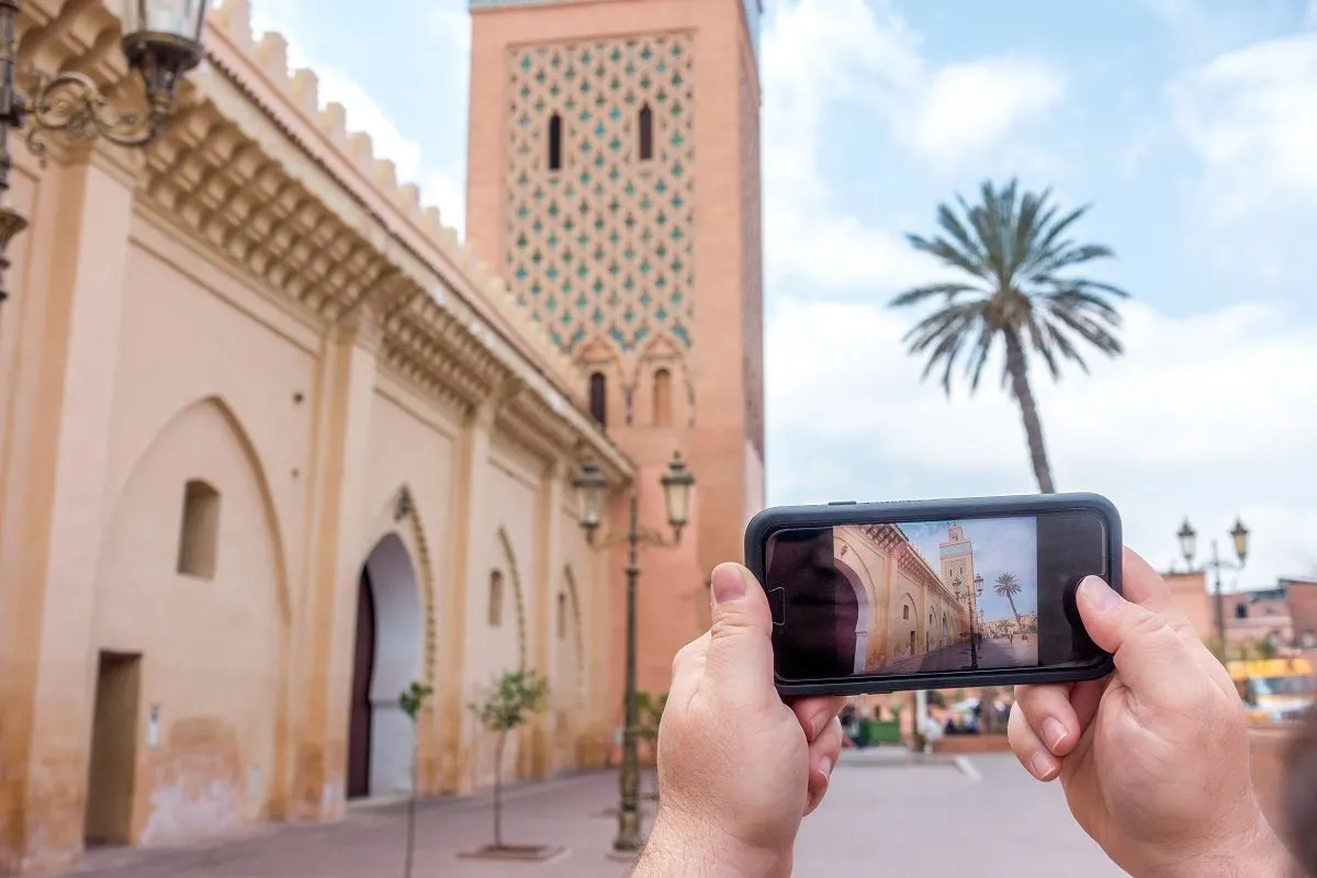 Taking an iPhone photo at the Marrakech Kasbah mosque using a travel wifi device.A internatTional travel wifi device, like ROAMING MAN, allowed us to post directly to our social media accounts. The additional access to information and sense of security were additional benefits.