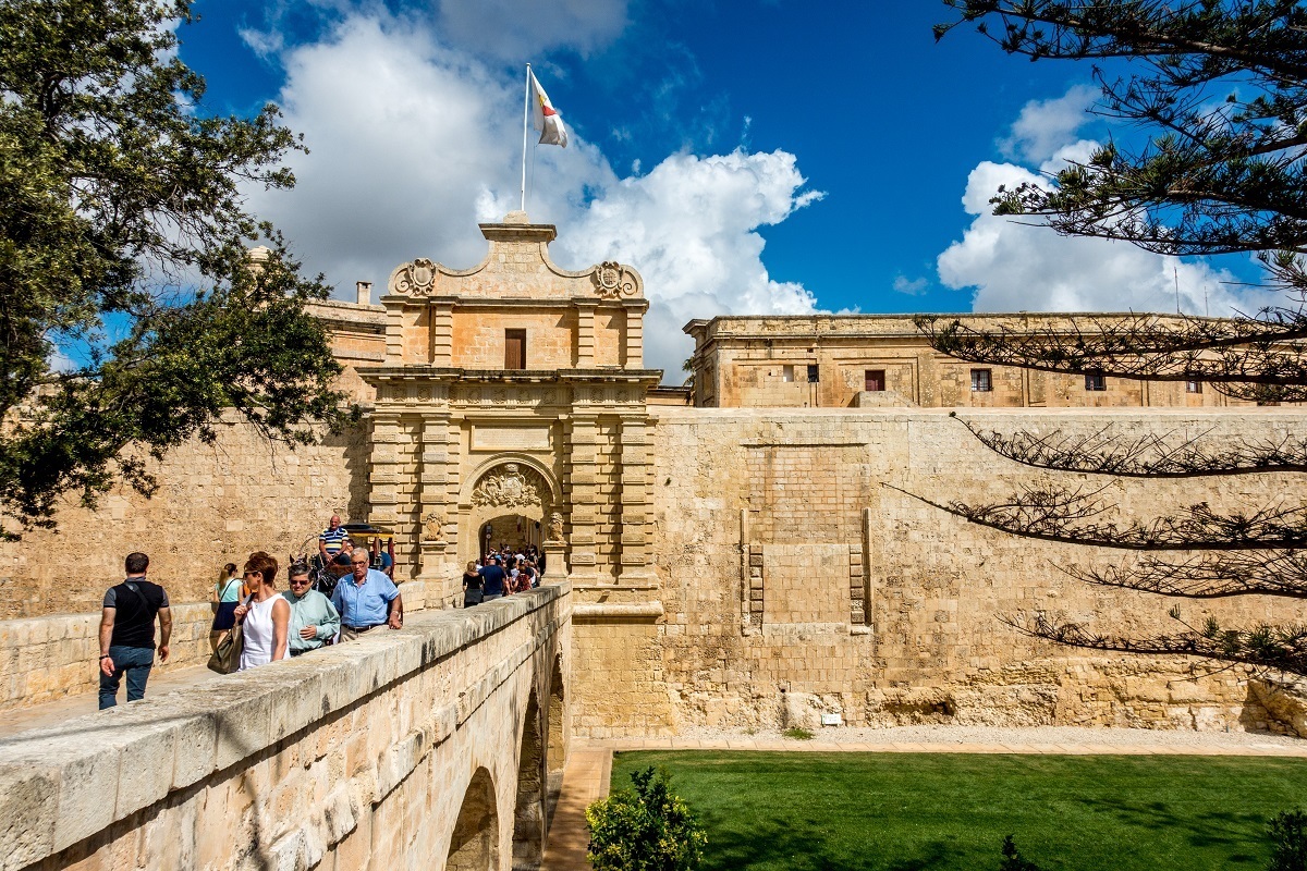 Crossing through the main gate of Mdina, Malta. A visit here is one of the top things to do in 4 days in Malta.